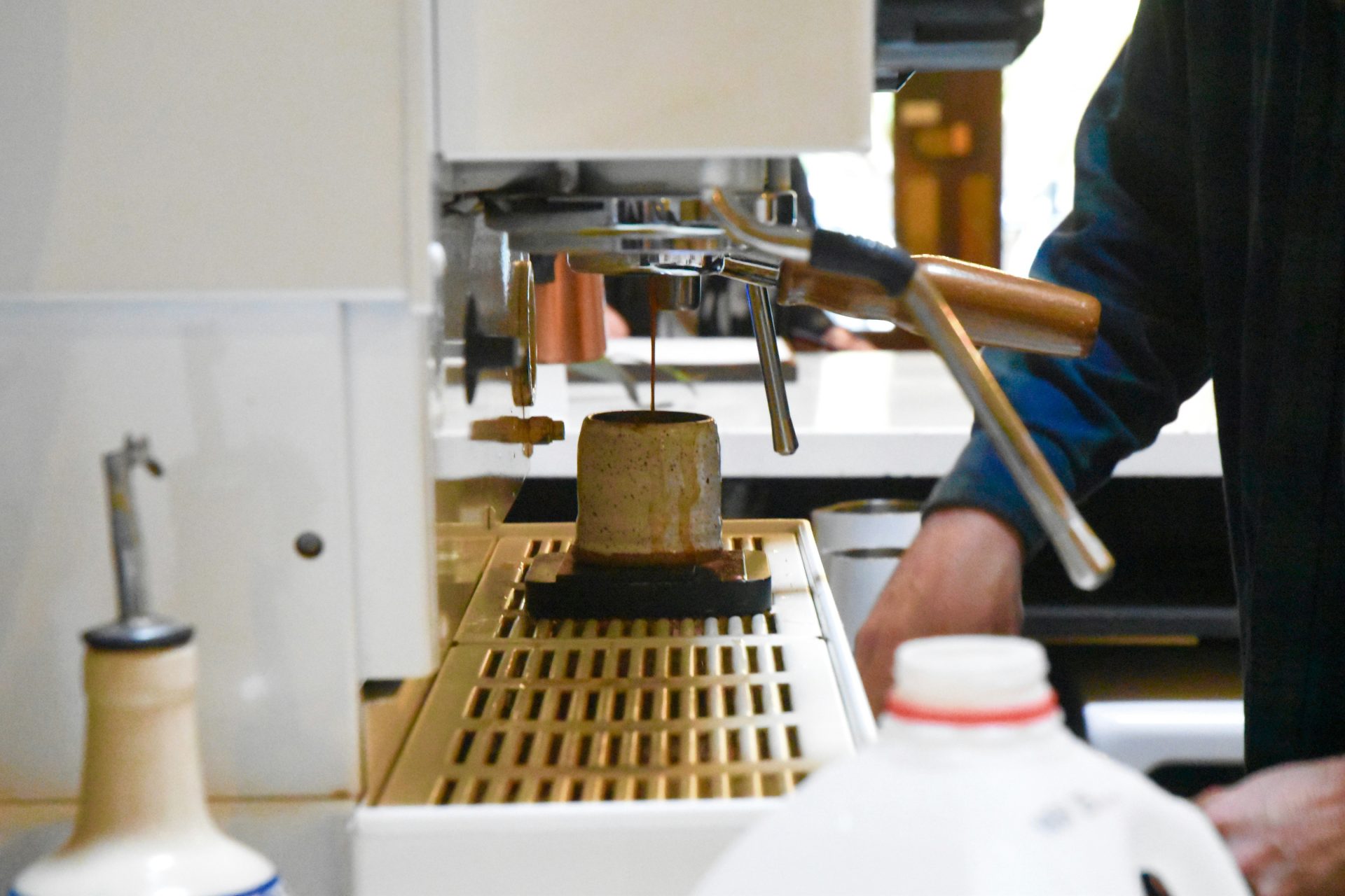 Espresso machine brewing coffee into mug