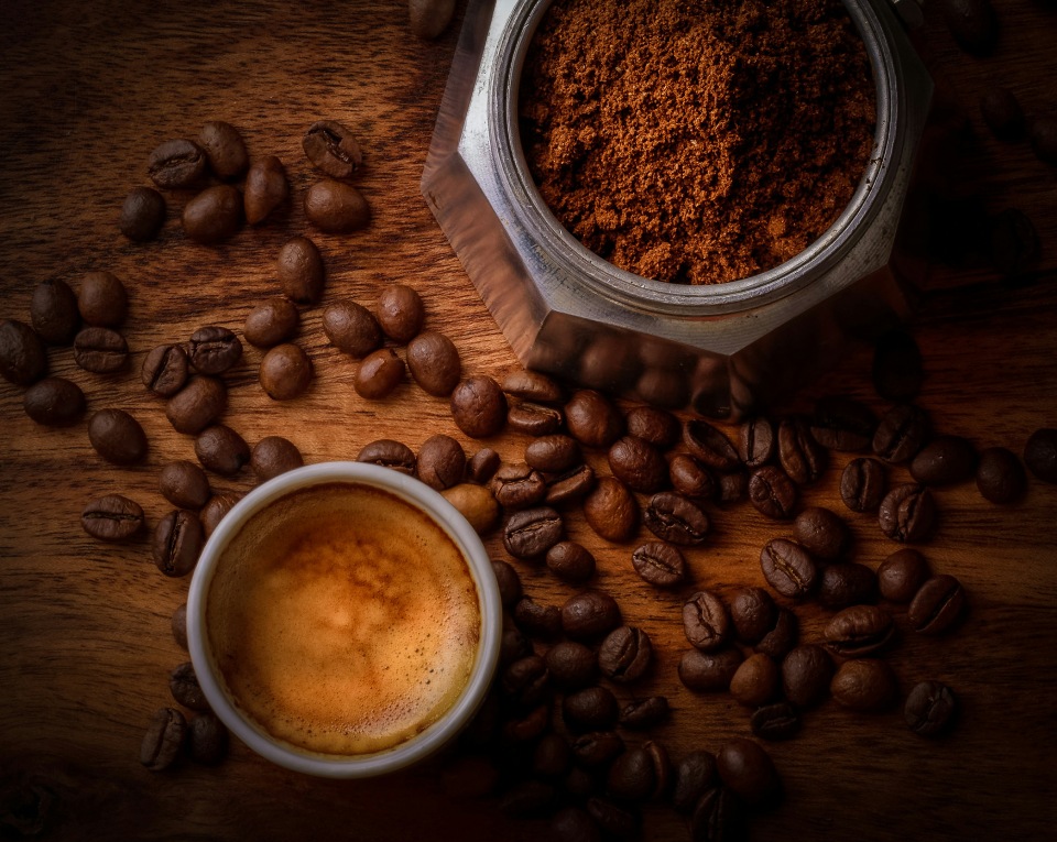 Coffee cup with coffee beans grounds.