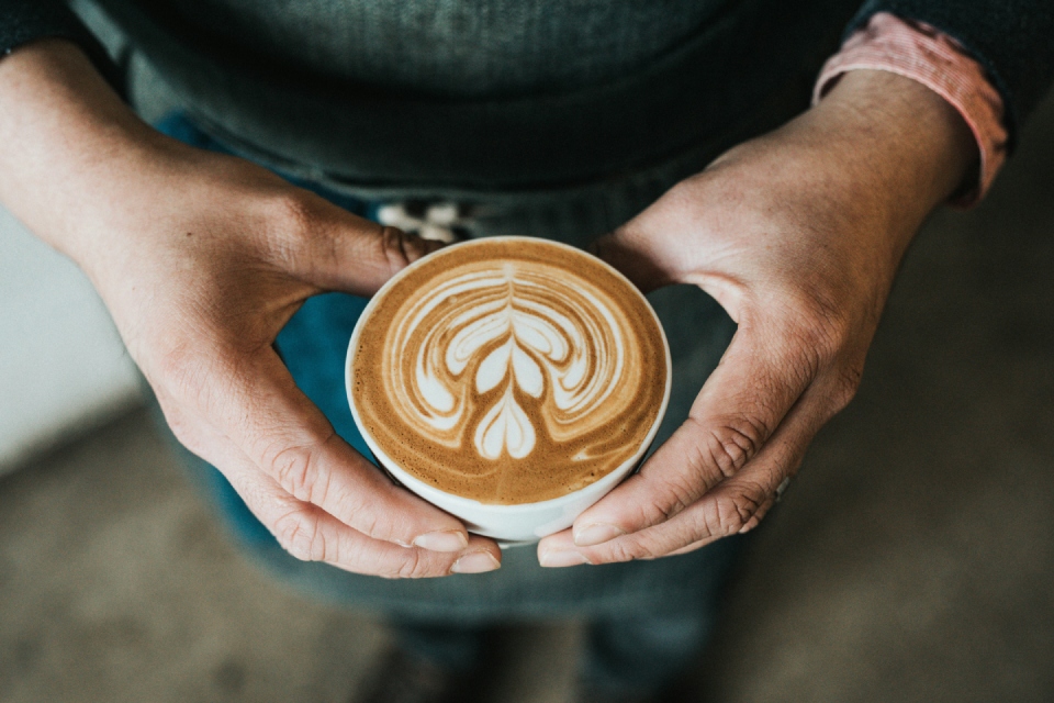 Person holding a beautifully crafted latte